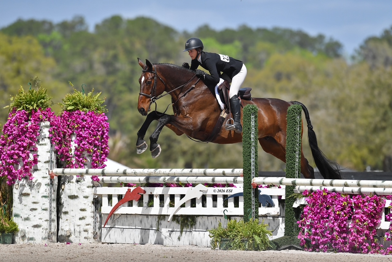 Mavery Regn riding over a jump during competition